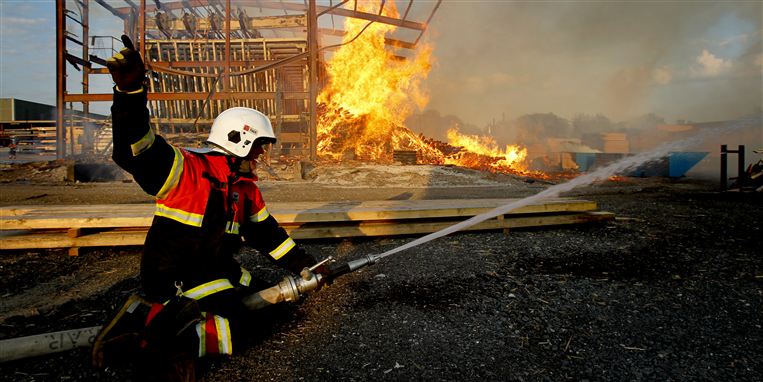 Den danske brandmand på billedet her er ved at slukke en ildebrand på et savværk uden at bære maske og ilt-apparat. Det er netop konsekvensen ved at gentage den adfærd brand efter brand, der kan være uhelbredelig kræft.