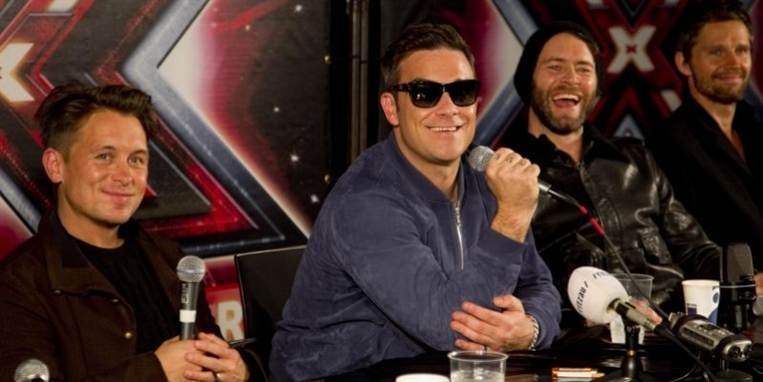 Robbie og resten af Take That var i godt humør, da de mødte den danske presse