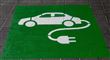 logo af elbil med ledning ses på asfalt 