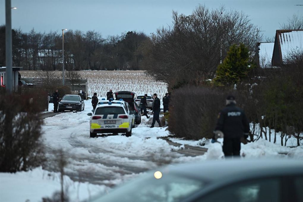 flere politibiler på en sneklædt dansk villa vej. 