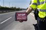 Færdelsbejtent med skilt med påskriften "Stop - Politiet" 