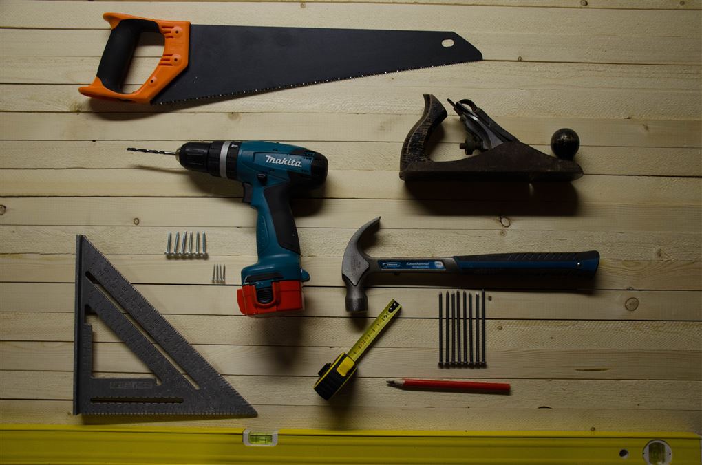 En del værktøj såsom sav, høvl, boremaskine, hammer etc. lagt sirligt i orden på et bord