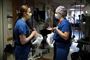To sygeplejersker med mundbind taler sammen på en hospitalsgang