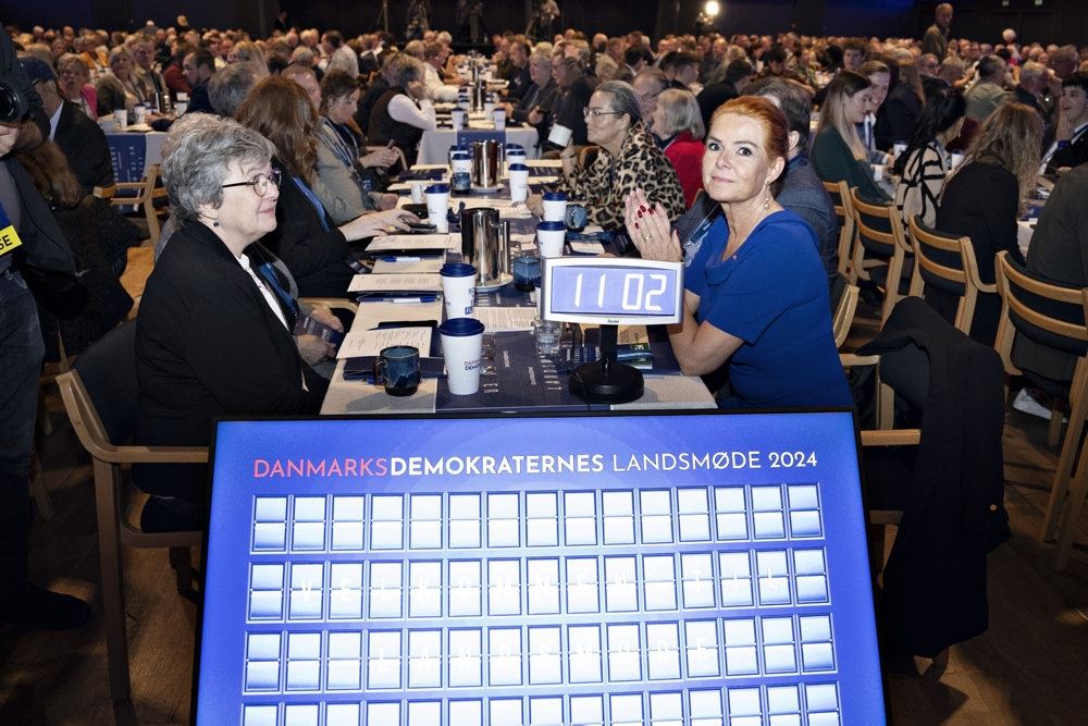 en kvinde sidder ved et langt bord