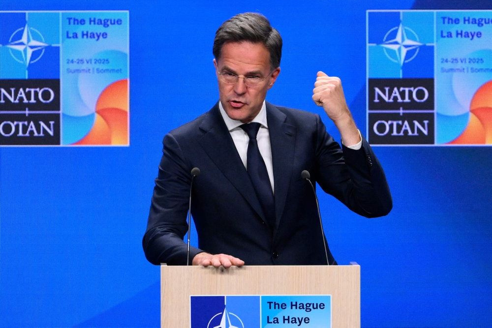 mand på talerstiol med knyttet hånd