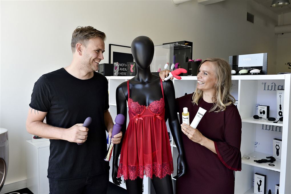 En mand og en kvinde med en mannequin iført rødt lingeri imellem sig